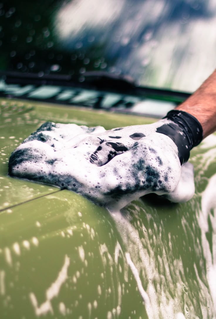 Hand wash mitt on green paint